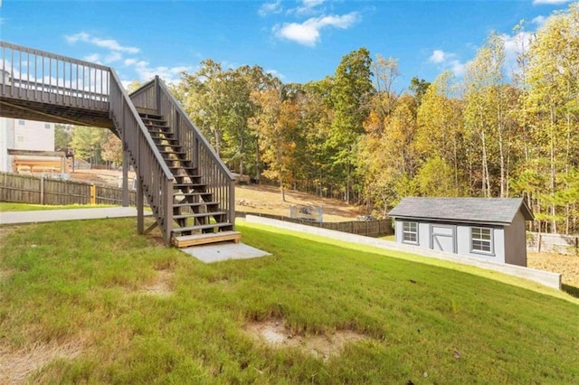 view of yard featuring a deck and a shed