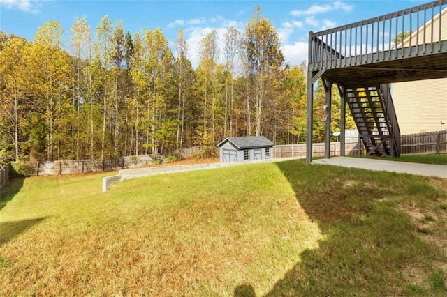 view of yard with a storage unit and a wooden deck