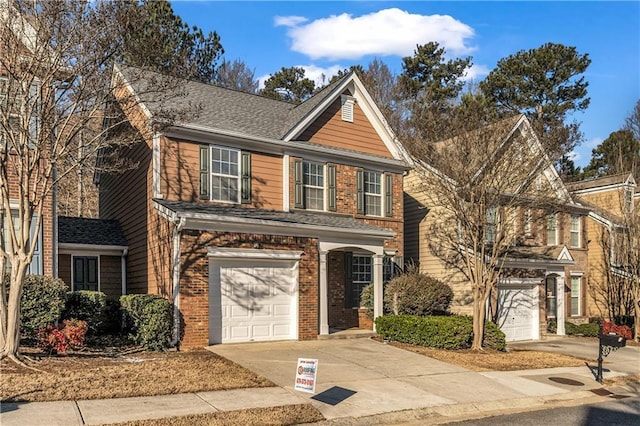 traditional home featuring a garage, driveway, brick siding, and a shingled roof