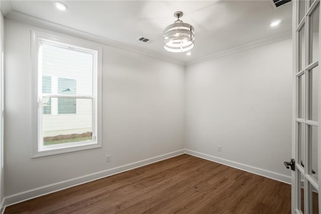 spare room with crown molding and dark hardwood / wood-style floors