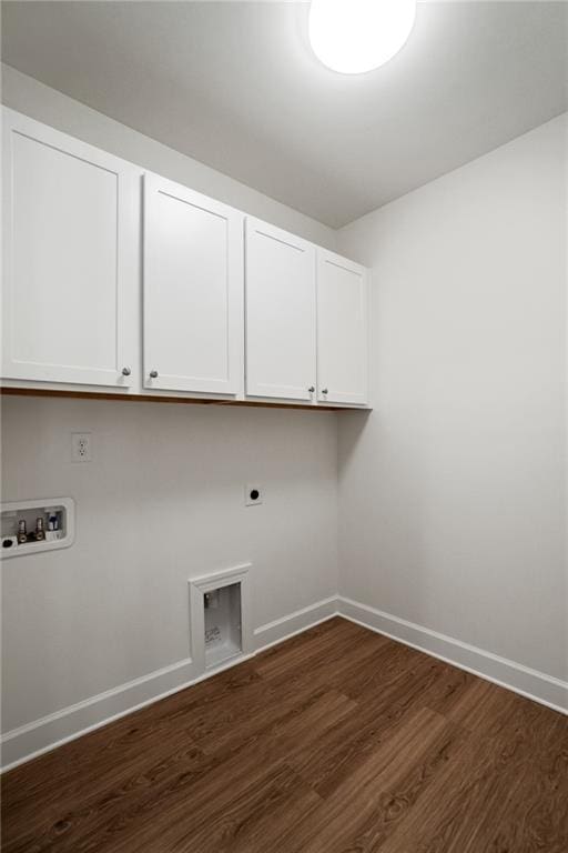 clothes washing area with cabinets, dark hardwood / wood-style floors, hookup for a washing machine, and hookup for an electric dryer