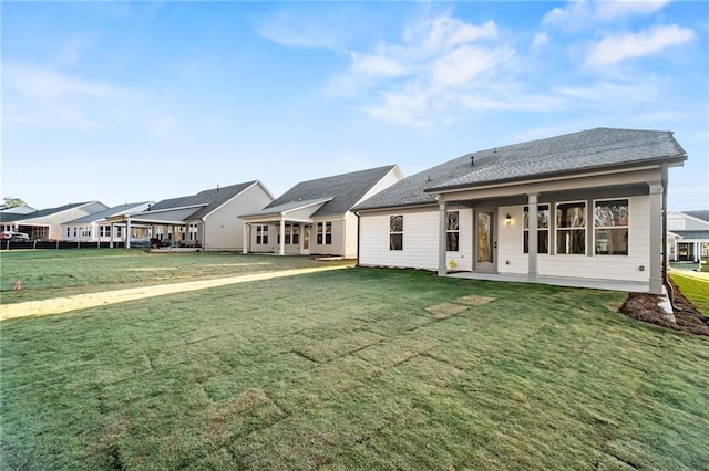 back of house featuring a lawn