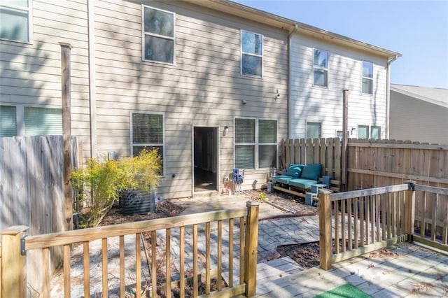 back of house featuring a patio, fence, and an outdoor living space