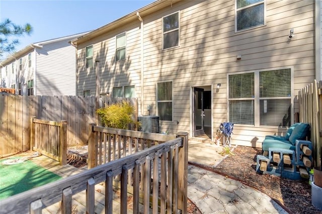 back of property featuring a patio area and fence