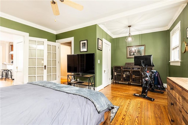 bedroom with wood finished floors, ornamental molding, baseboards, french doors, and ceiling fan