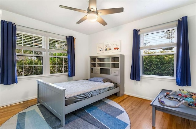 bedroom featuring hardwood / wood-style floors and ceiling fan