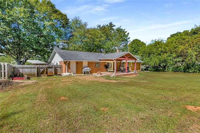 back of house featuring a yard and a patio