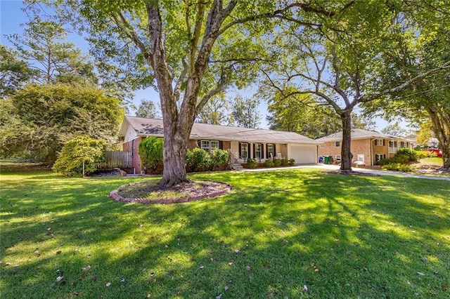 ranch-style home featuring a front yard and a garage