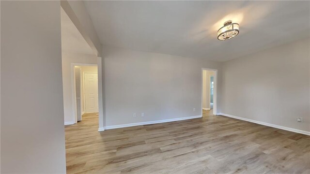 hallway with light hardwood / wood-style floors