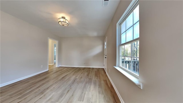 empty room with light hardwood / wood-style flooring