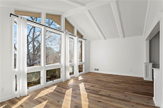 unfurnished sunroom featuring lofted ceiling with beams and visible vents