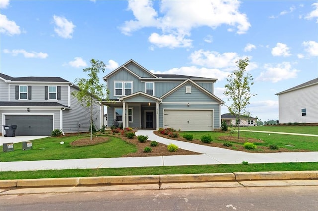 craftsman-style home with covered porch, a garage, and a front yard