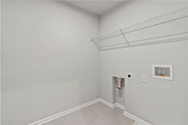 laundry area with electric dryer hookup, light tile patterned floors, and washer hookup