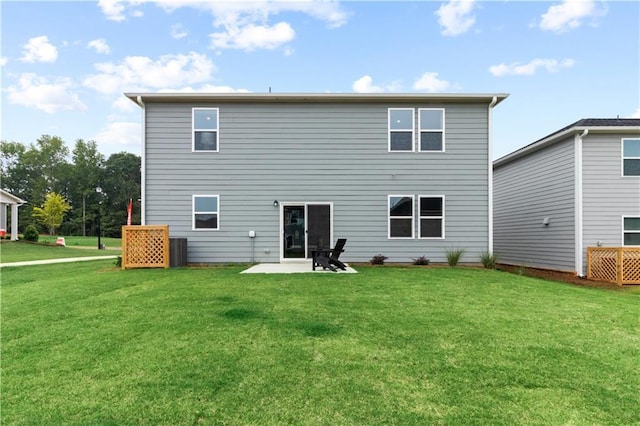 rear view of property featuring a yard and a patio