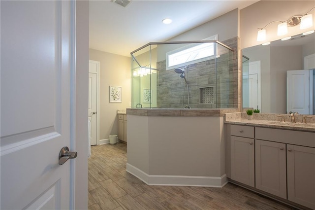 3719 Cresswind Pkwy SW, Gainesville, GA 30504 - bathroom with vanity, a shower stall, and wood finished floors
