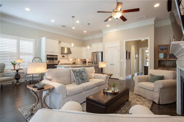 3719 Cresswind Pkwy SW, Gainesville, GA 30504 - living area featuring a ceiling fan, dark wood-style floors, ornamental molding, a fireplace, and recessed lighting