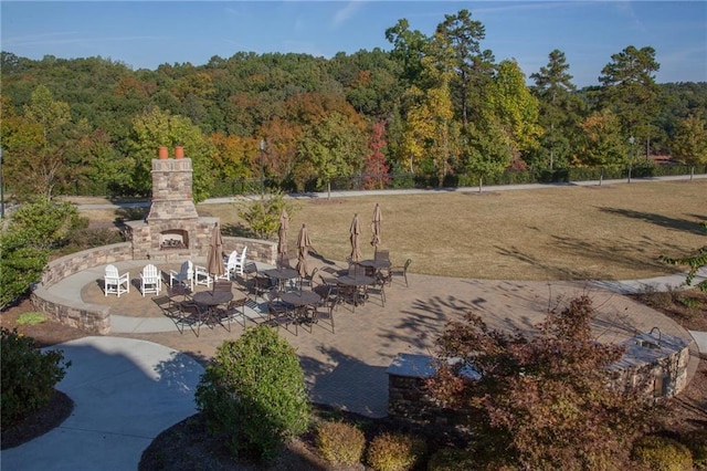 3719 Cresswind Pkwy SW, Gainesville, GA 30504 - view of yard with an outdoor stone fireplace, a forest view, and a patio
