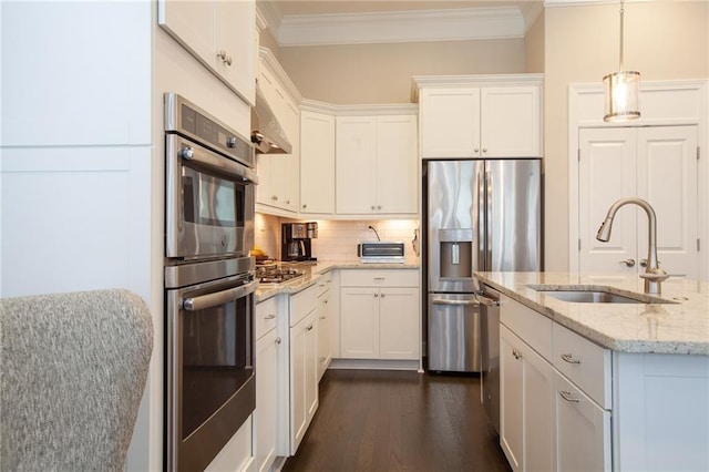 3719 Cresswind Pkwy SW, Gainesville, GA 30504 - kitchen featuring appliances with stainless steel finishes, crown molding, dark wood finished floors, white cabinets, and decorative backsplash