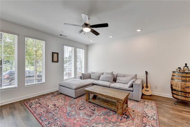 living room with hardwood / wood-style flooring and ceiling fan