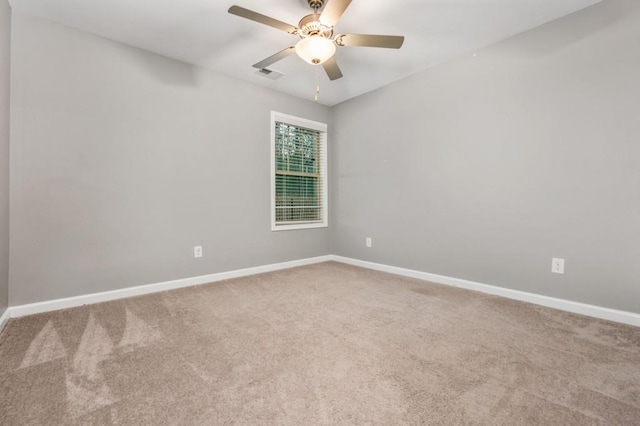 spare room featuring carpet flooring and ceiling fan