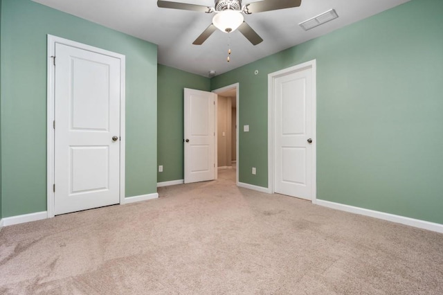 unfurnished bedroom with ceiling fan and light colored carpet