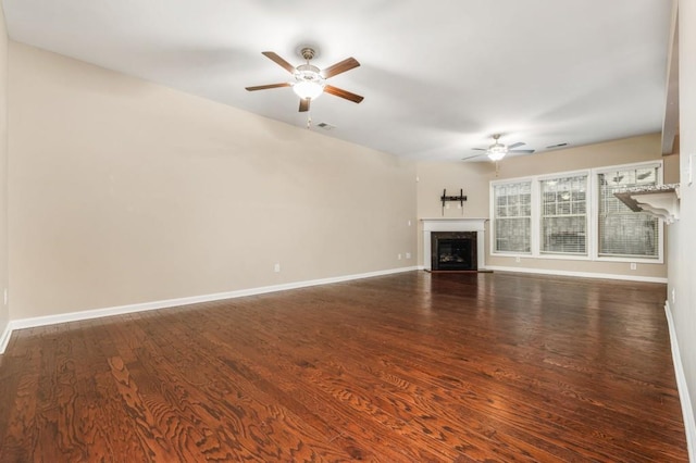 unfurnished living room featuring ceiling fan and dark hardwood / wood-style flooring