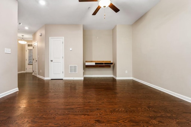 unfurnished room with ceiling fan and dark wood-type flooring