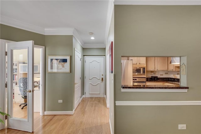 hall featuring crown molding, baseboards, recessed lighting, and light wood finished floors