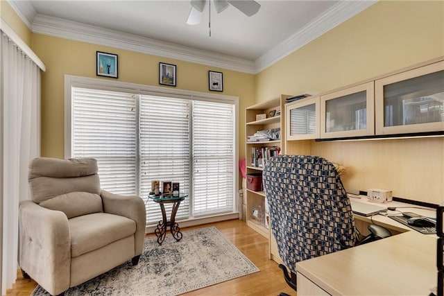 home office with crown molding, light wood-style floors, and ceiling fan