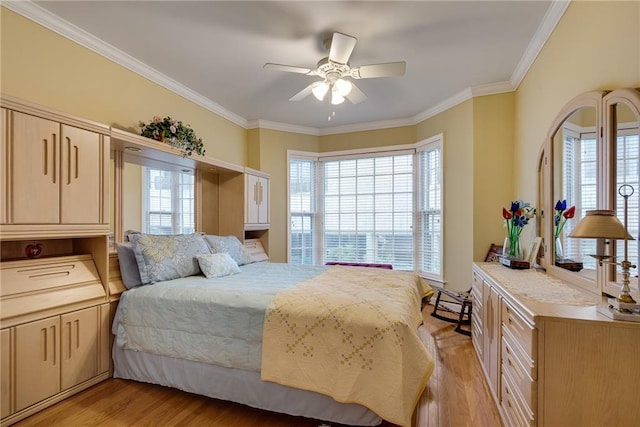 bedroom with crown molding, light wood-style flooring, and ceiling fan