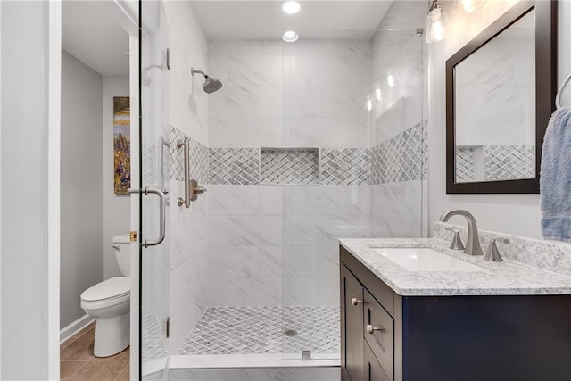bathroom featuring vanity, recessed lighting, a stall shower, and toilet