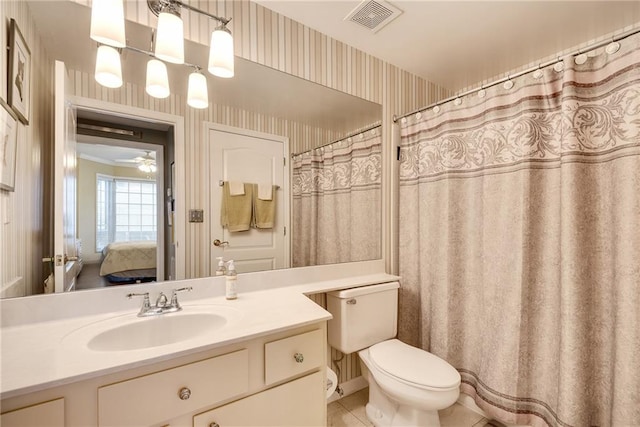ensuite bathroom with visible vents, tile patterned flooring, vanity, toilet, and wallpapered walls