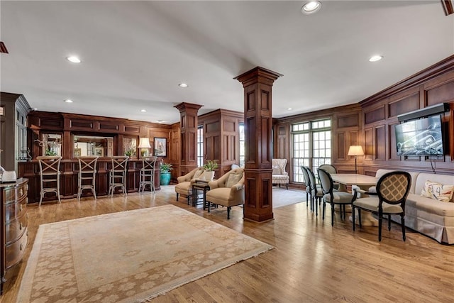 interior space with ornate columns, recessed lighting, and a decorative wall