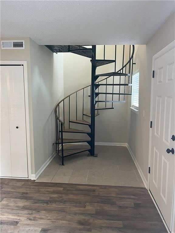 4701 Flat Shoals Rd Unit 41-F, Union City, GA 30291 - stairway featuring wood finished floors, baseboards, and a textured ceiling