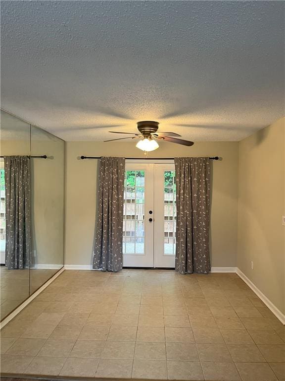 4701 Flat Shoals Rd Unit 41-F, Union City, GA 30291 - empty room featuring ceiling fan, plenty of natural light, a textured ceiling, french doors, and baseboards