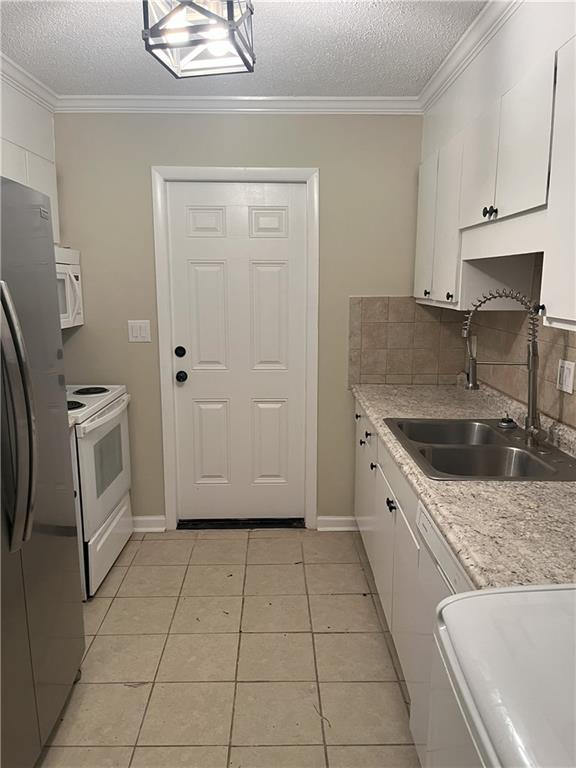 4701 Flat Shoals Rd Unit 41-F, Union City, GA 30291 - kitchen featuring white appliances, a sink, white cabinetry, a textured ceiling, and light countertops