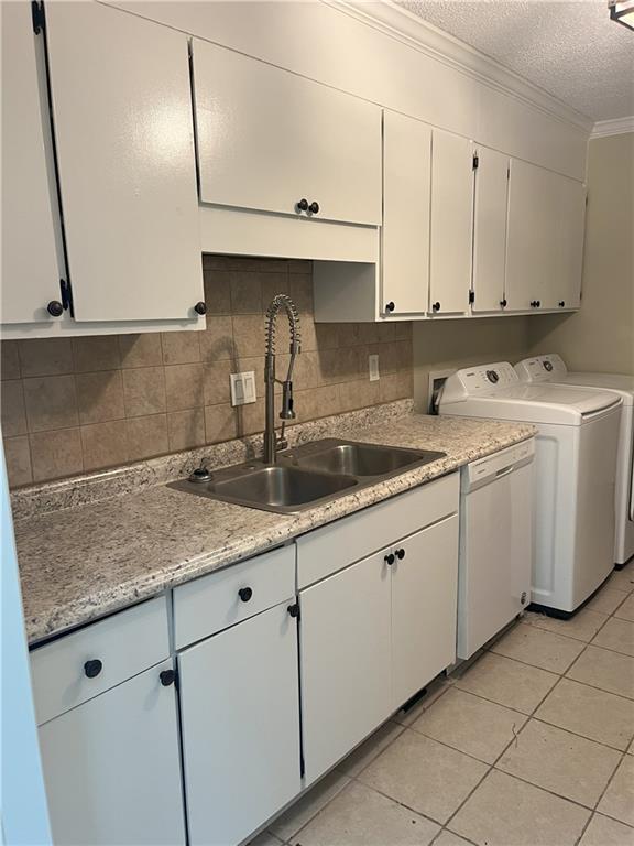 4701 Flat Shoals Rd Unit 41-F, Union City, GA 30291 - kitchen featuring a sink, white dishwasher, crown molding, light countertops, and white cabinets