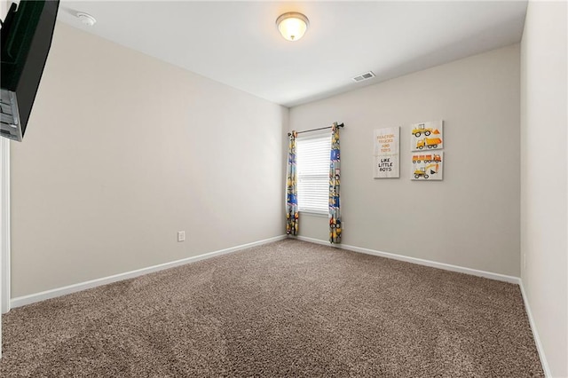 carpeted empty room featuring visible vents and baseboards