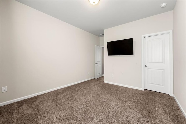 unfurnished bedroom featuring carpet floors and baseboards