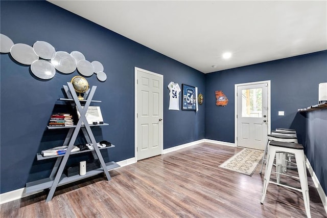 entryway featuring wood finished floors and baseboards