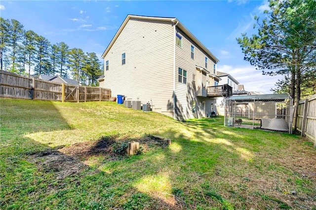 back of house featuring a fenced backyard, cooling unit, and a lawn