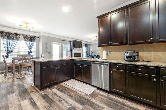 kitchen featuring a peninsula, ornamental molding, dishwasher, and wood finished floors