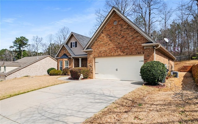 view of front facade with concrete driveway, central air condition unit, an attached garage, and brick siding