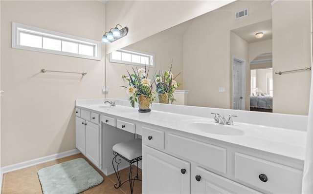 full bathroom featuring ensuite bath, double vanity, visible vents, and a sink