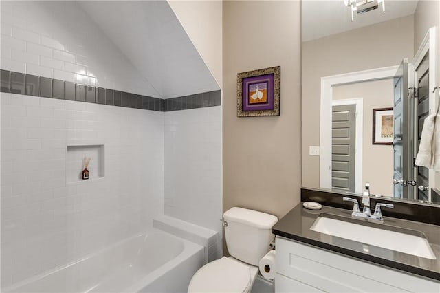 bathroom with vaulted ceiling, toilet, vanity, and washtub / shower combination