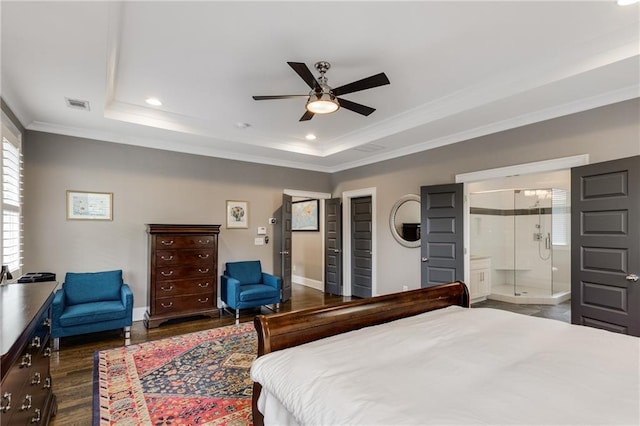 bedroom with dark wood-style floors, a raised ceiling, baseboards, visible vents, and ornamental molding