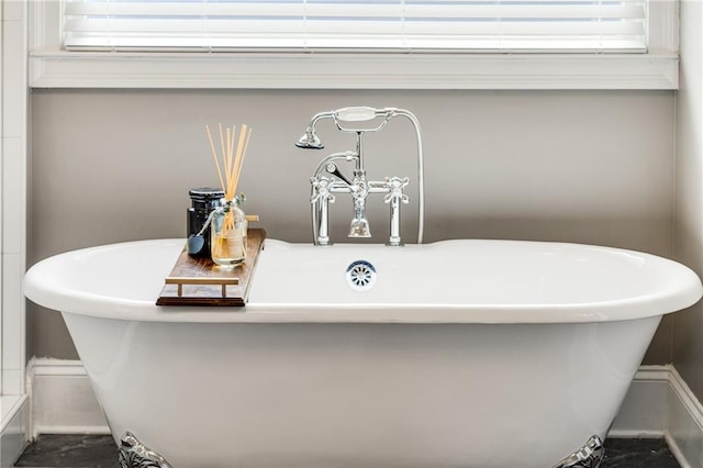 room details featuring a soaking tub and a sink