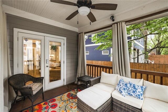 sunroom with ceiling fan, outdoor lounge area, and french doors