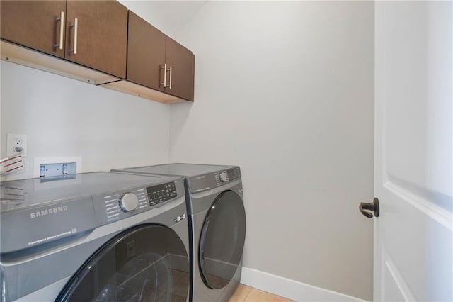 1199 Huff Rd NW Unit 112, Atlanta, GA 30318 - laundry area featuring cabinet space, separate washer and dryer, and light tile patterned floors