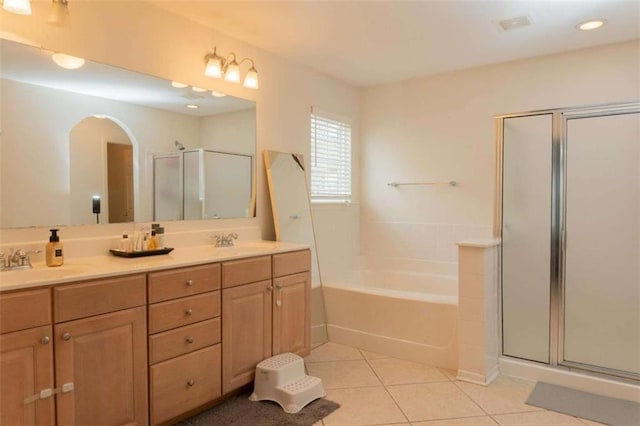 bathroom featuring tile patterned flooring, vanity, and shower with separate bathtub